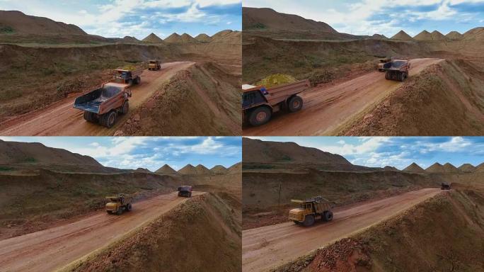 两辆自卸车从采石场运送矿石。矿山全景。巴尔汗·桑兹。矿产开发。