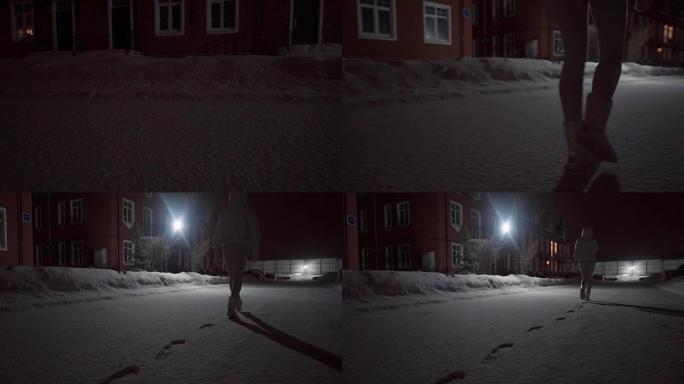 孤独的女孩在深夜沿着雪街走