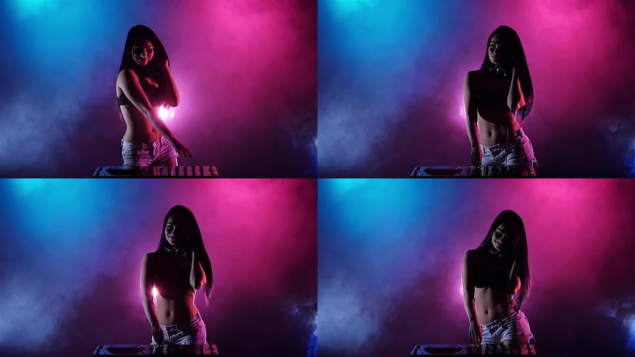 女孩DJ跳舞在她五彩缤纷的灯光和烟雾后面发展她的头发。剪影