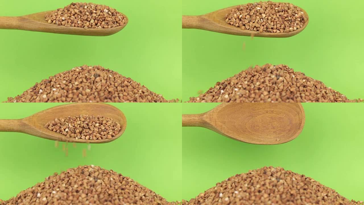 木勺将谷物荞麦倒在绿色屏幕上的荞麦堆上