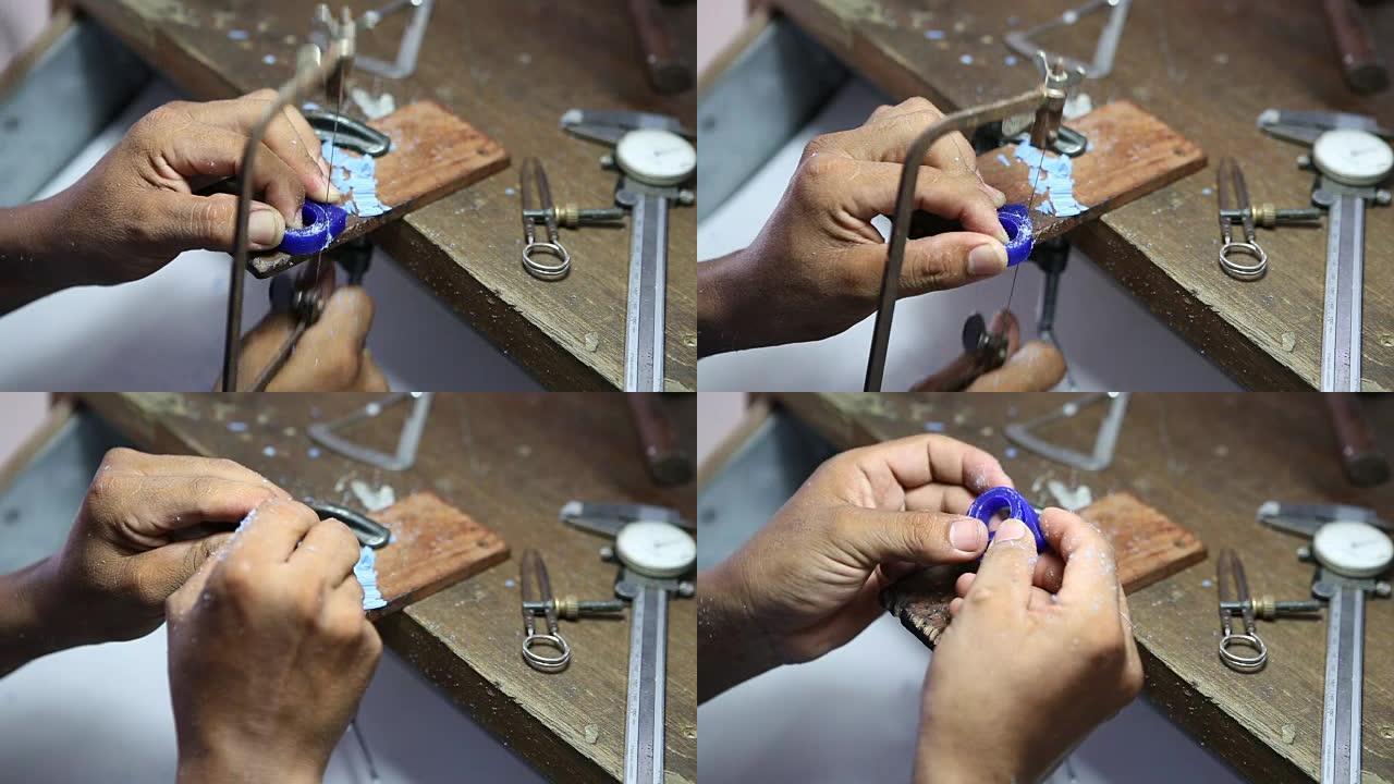 金匠用拼图切割蜡做戒指的蜡模