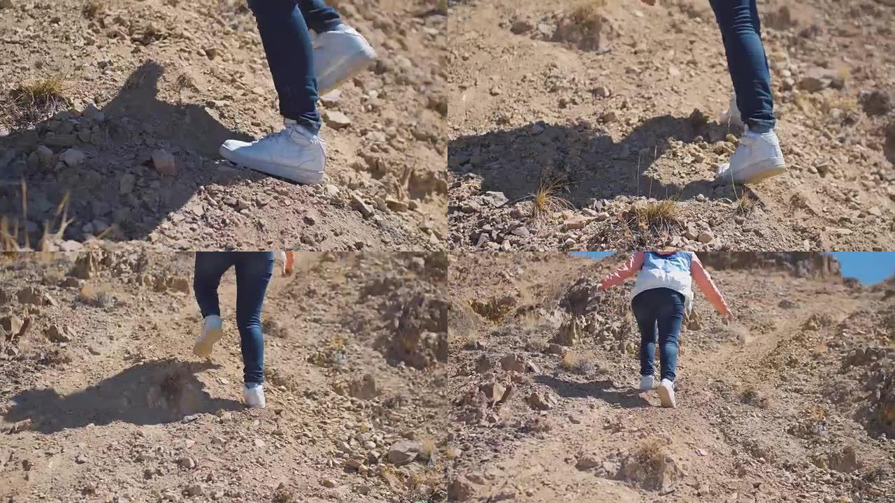 女人腿脚的特写镜头正在沙漠上爬山
