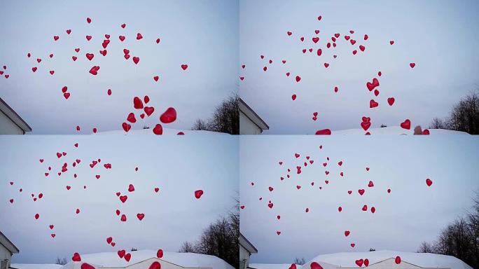 空中有很多红心气球