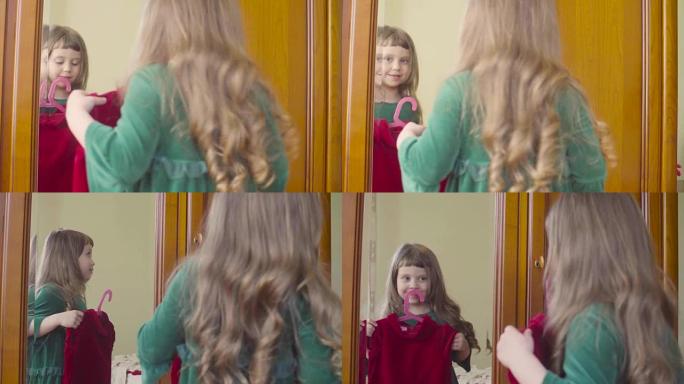 一个女孩在镜子里看着一件新衣服