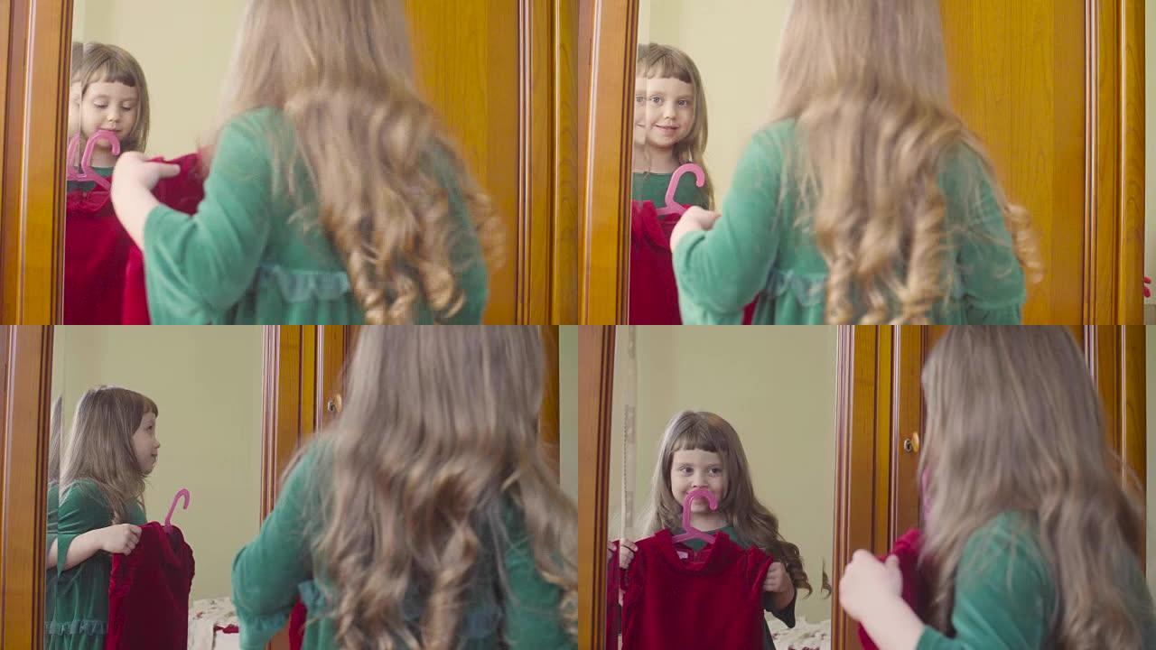 一个女孩在镜子里看着一件新衣服