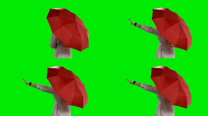 带红色雨伞的女人的后视图在绿色屏幕上挥舞着她的手