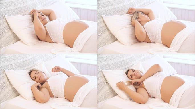 孕妇躺在床上拉直头发