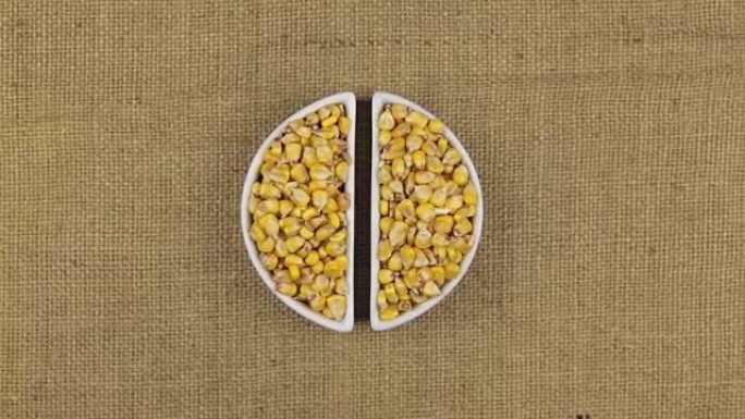 将玉米粒和小麦小穗放在麻布上的变焦盘
