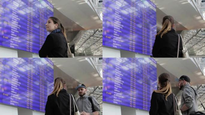 机场的几个游客关于信息屏幕。