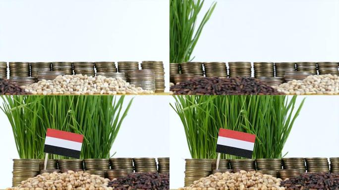 也门国旗挥舞着一堆硬币和一堆小麦