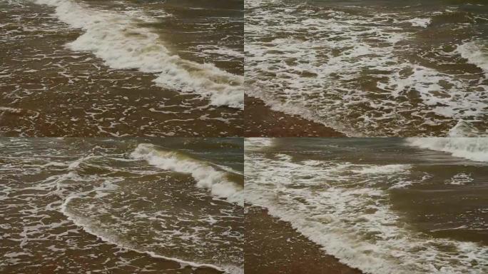 海浪在海上的岩石上破裂。小浪和圆形石头
