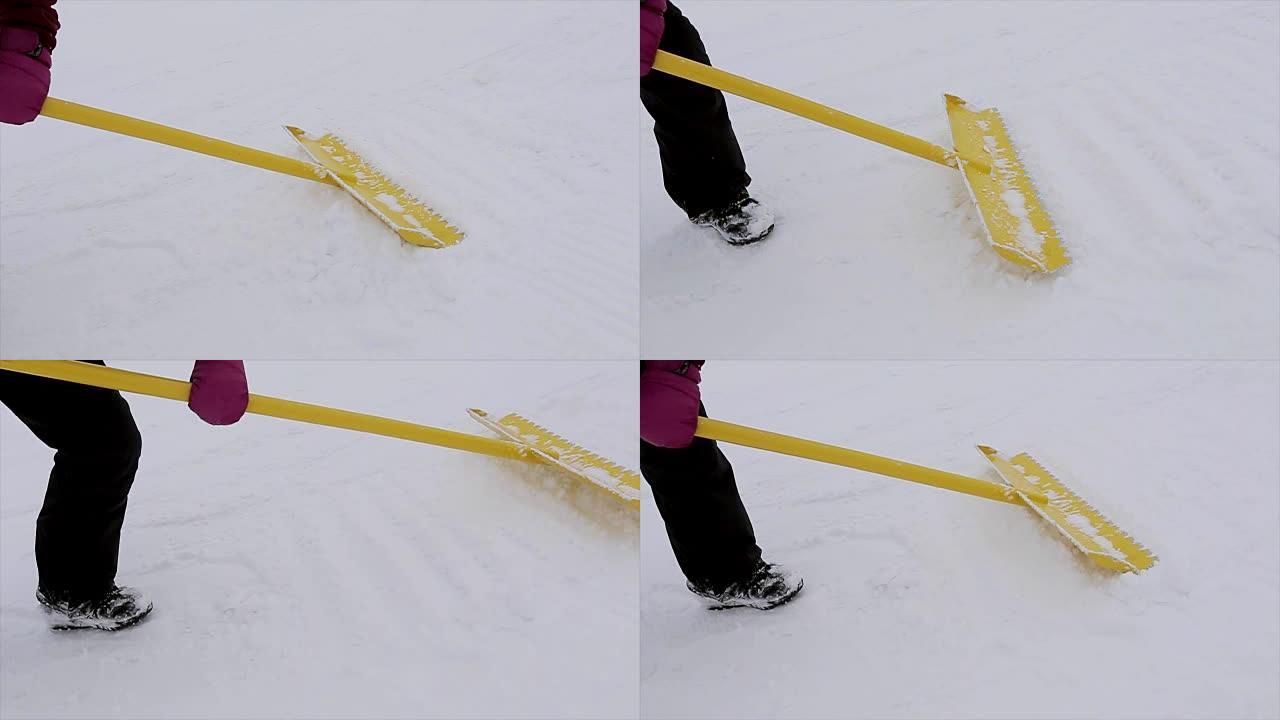 滑雪者在雪山用黄色铲子抚平雪。滑雪胜地。制服。冬天
