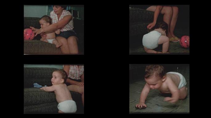 母亲给尿布中的男婴玩杯垫