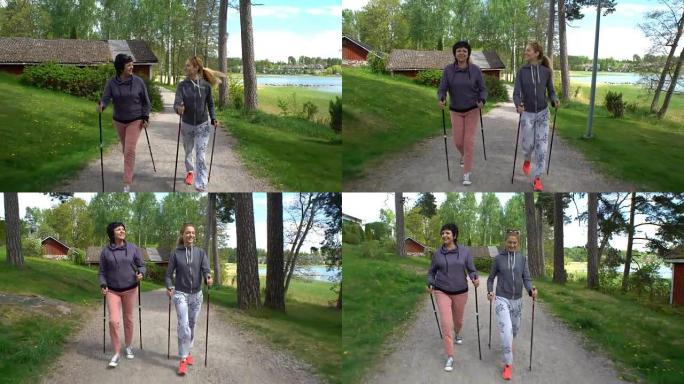 两个活跃的女人在公园里做北欧散步。跟踪镜头