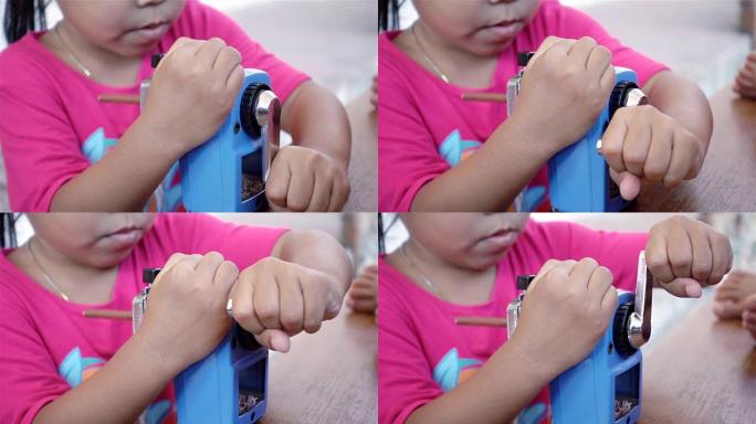 亚洲女孩用卷笔刀削尖的特写镜头，慢动作镜头