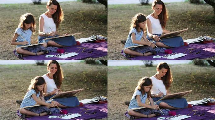 年轻女子在阳光明媚的夏日在公园教画一个女孩。