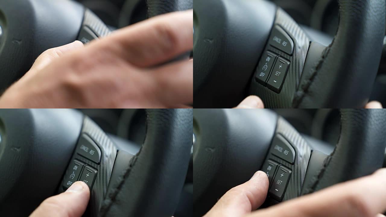 驾驶员的手按下汽车的车载电脑参数控制按钮