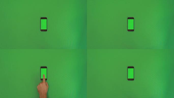 智能手机在绿色屏幕上点击手势。垂直