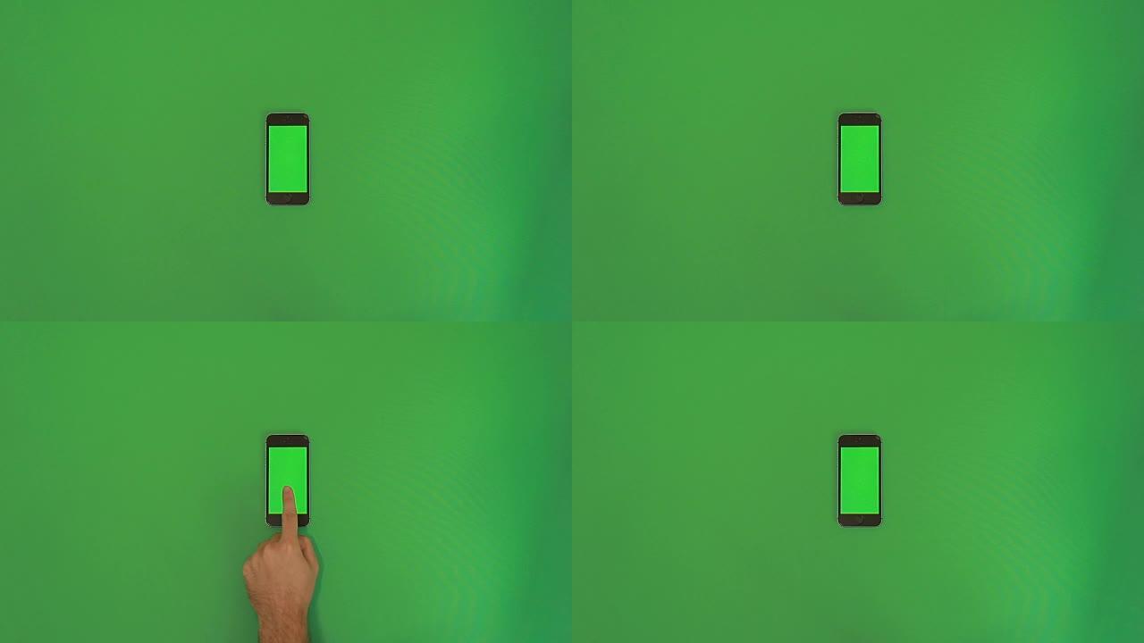 智能手机在绿色屏幕上点击手势。垂直
