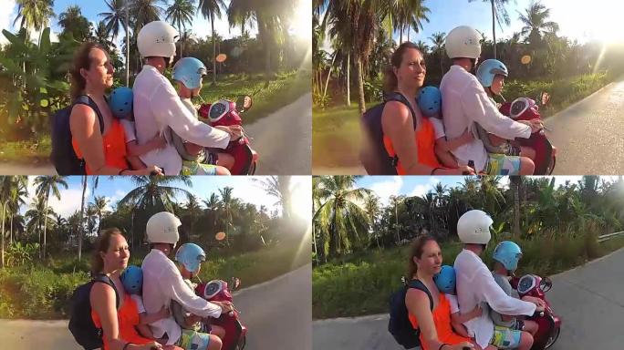 在热带地区骑摩托车的幸福家庭。阳光明媚的一天。泰国潘安