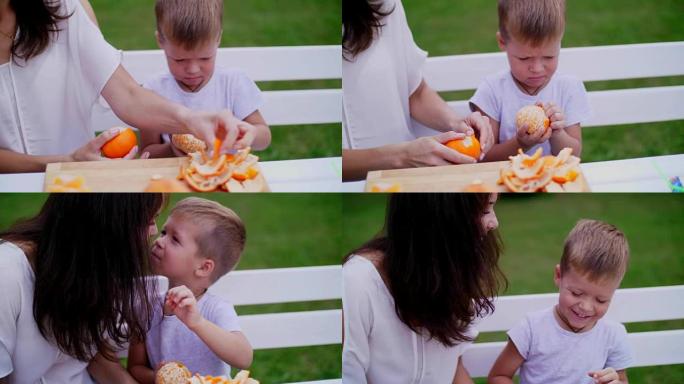 夏天，在花园里。妈妈和四岁的儿子用橘子皮清洗。他们想做新鲜果汁