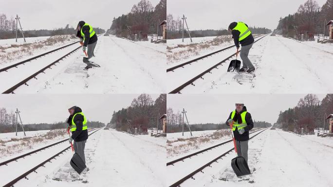 铁路员工清理铁路附近的积雪并走开