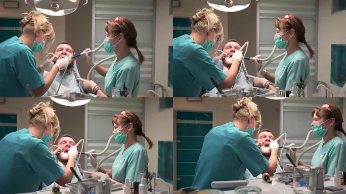 牙医和助手去除牙齿上的牙菌斑。Steadicam