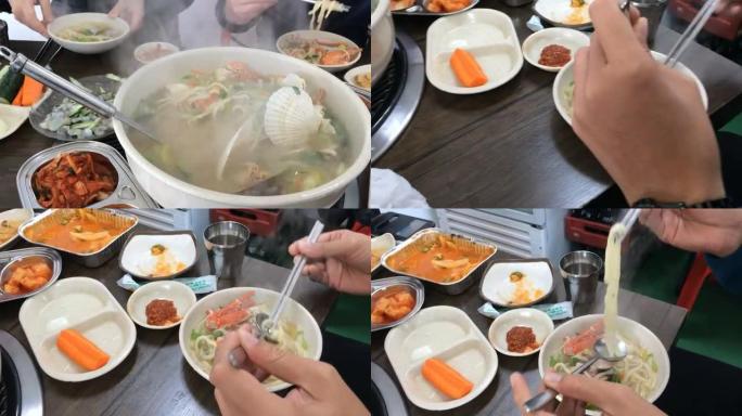 韩国海鲜汤拌面条和蔬菜配菜。
