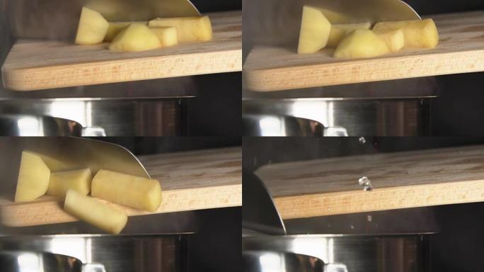 慢: 库克扔了切成薄片的土豆 (特写)