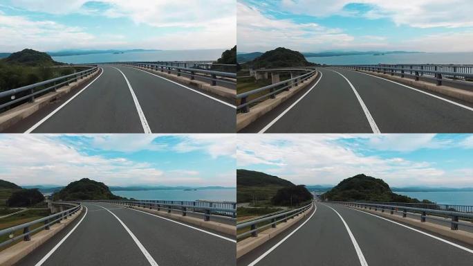 在海洋 “Tsunoshima桥” 上空空旷直路的驾驶镜头