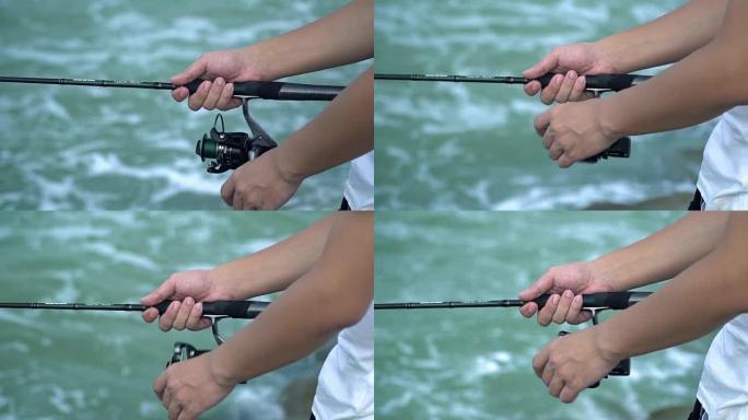 男性旋转钓鱼竿夏季户外活动