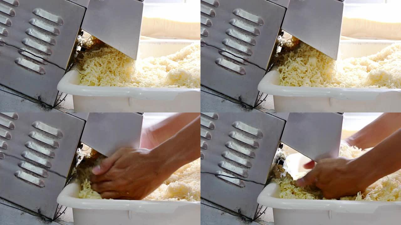 在工厂制作奶酪的过程。特写。切片奶酪机