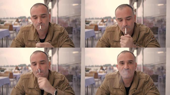 大胆的中年男子喝热咖啡，抽雪茄，在咖啡馆享受户外活动的特写镜头