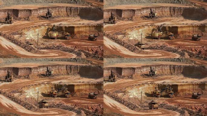 挖掘机将矿石装载到自卸卡车中。这个地区开采矾土、铝和其他矿物。露天。我操作。铝土矿的猎物。