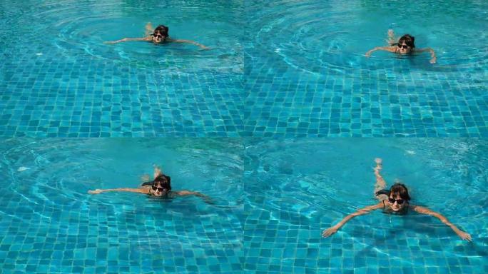 快乐的女人在游泳池里放松