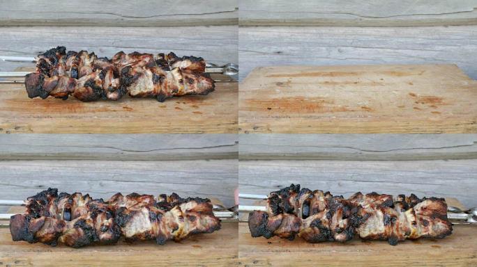 烤肉中的熟肉放在木板上。红润，轻微烧焦的碎片。背景上的木墙