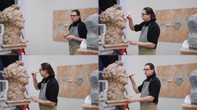 雕塑家造型雕塑调整面部细节用粘土制成的头部