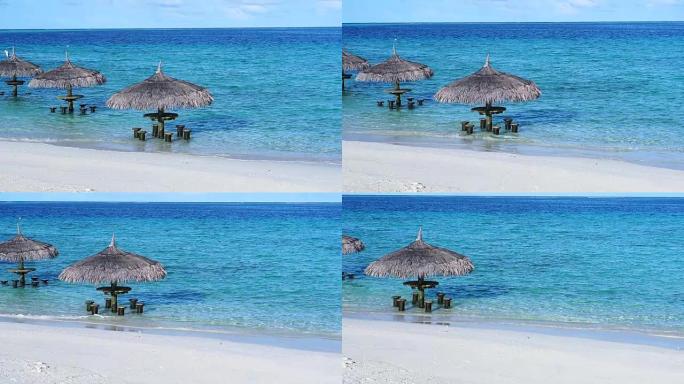 马尔代夫海滩的海洋酒吧。绿松石蓝色大海中的热带小屋座位以慢动作拍摄