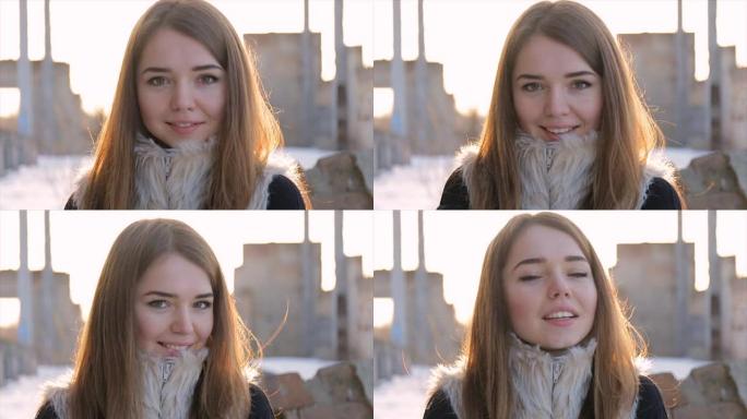 在废弃建筑物的背景上穿着羊皮大衣的女孩。慢动作