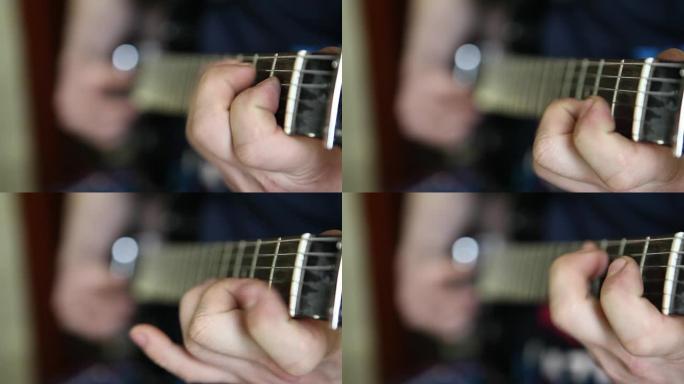 男人弹吉他，手指放在指板上