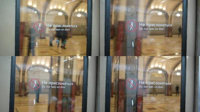 到达莫斯科的Mayakovskaya地铁站。从带有 “请勿靠在门上” 标签的地铁玻璃门上观看