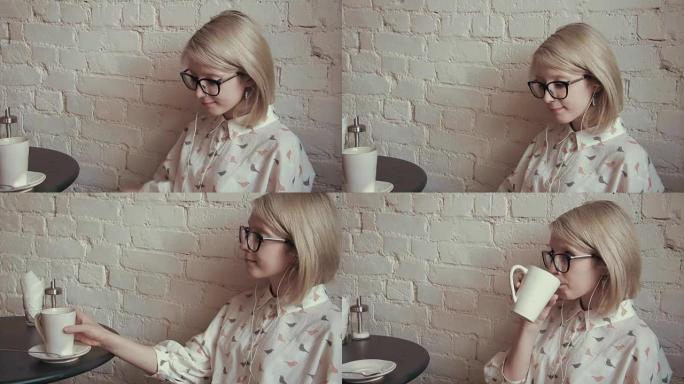 快乐的年轻美女在咖啡馆喝咖啡，在ipod上听音乐
