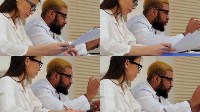 Afroamerican男医生和女护士通过笔记本电脑上的视频通话开药
