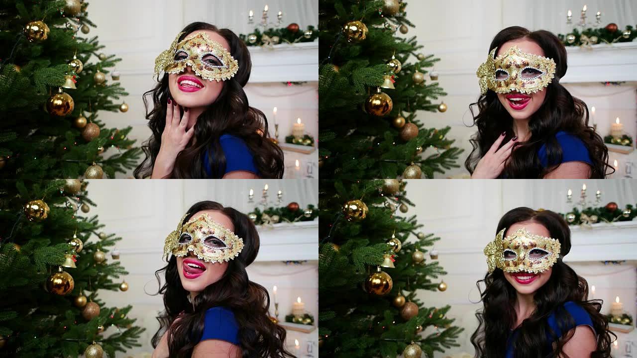 戴着面具庆祝新年的美丽女孩，圣诞节化妆舞会，圣诞树附近的派对，一个穿着漂亮晚礼服的年轻女子