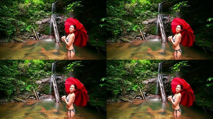 婆罗洲雨林瀑布带雨伞的女孩