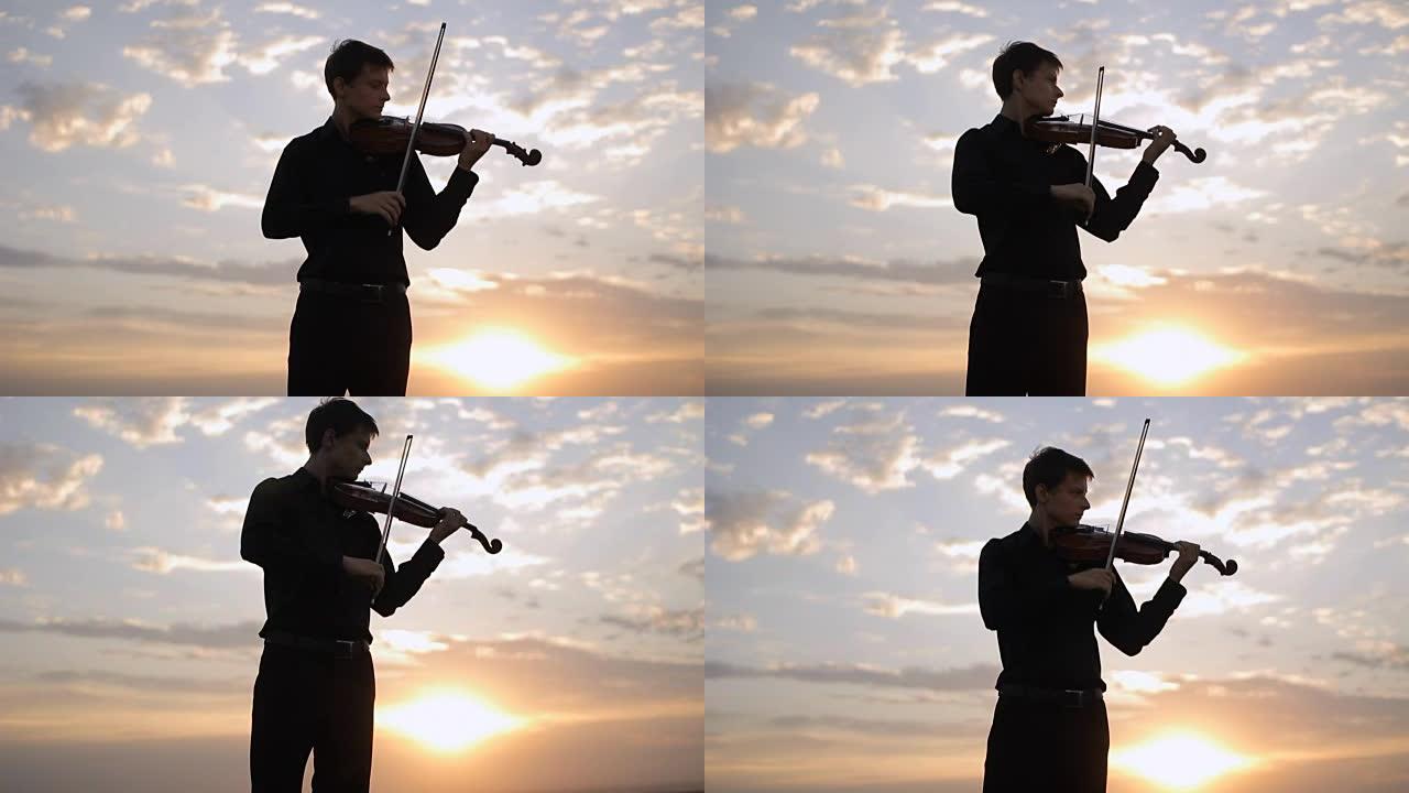 小提琴手在日落时在屋顶上演奏。音乐，艺术