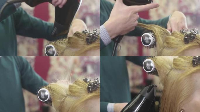 理发师在美容院用梳子和吹风机将头发根部提升到金发女孩。制作发型