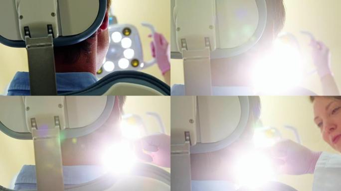 女牙医开灯检查病人的低角度特写