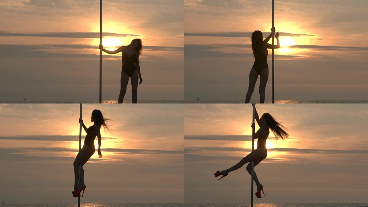 日落时沙滩上的钢管舞健身运动