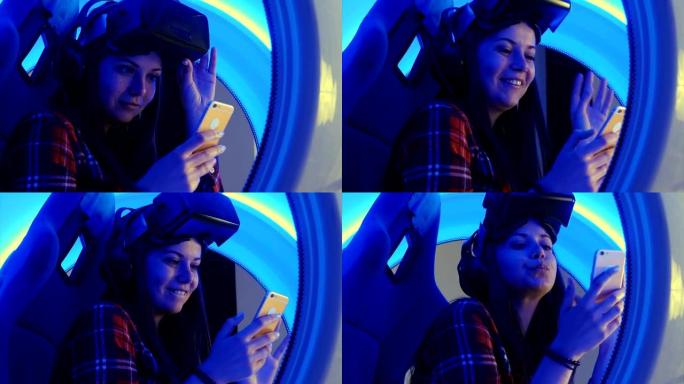 虚拟现实耳机里开朗的女孩在手机上检查她的自拍